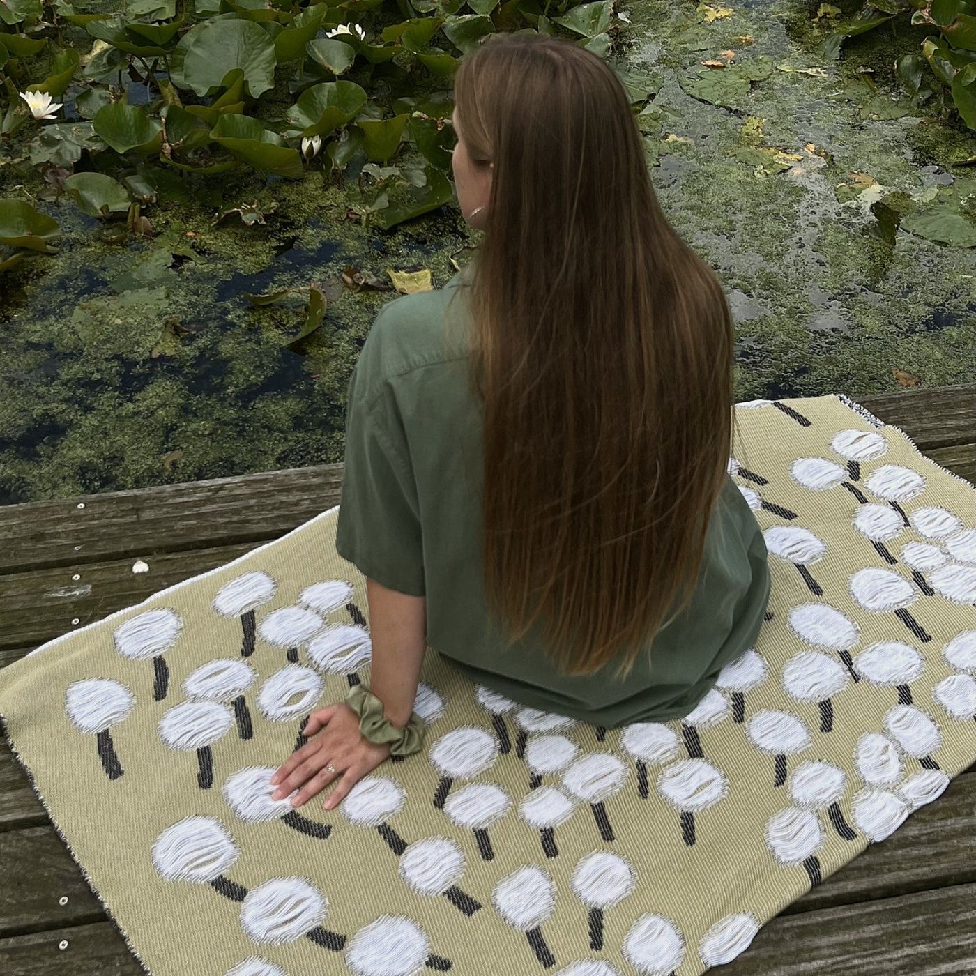 Olive green cotton blanket with abstract dandelion botanical pattern, designed by Liucija Kostiva