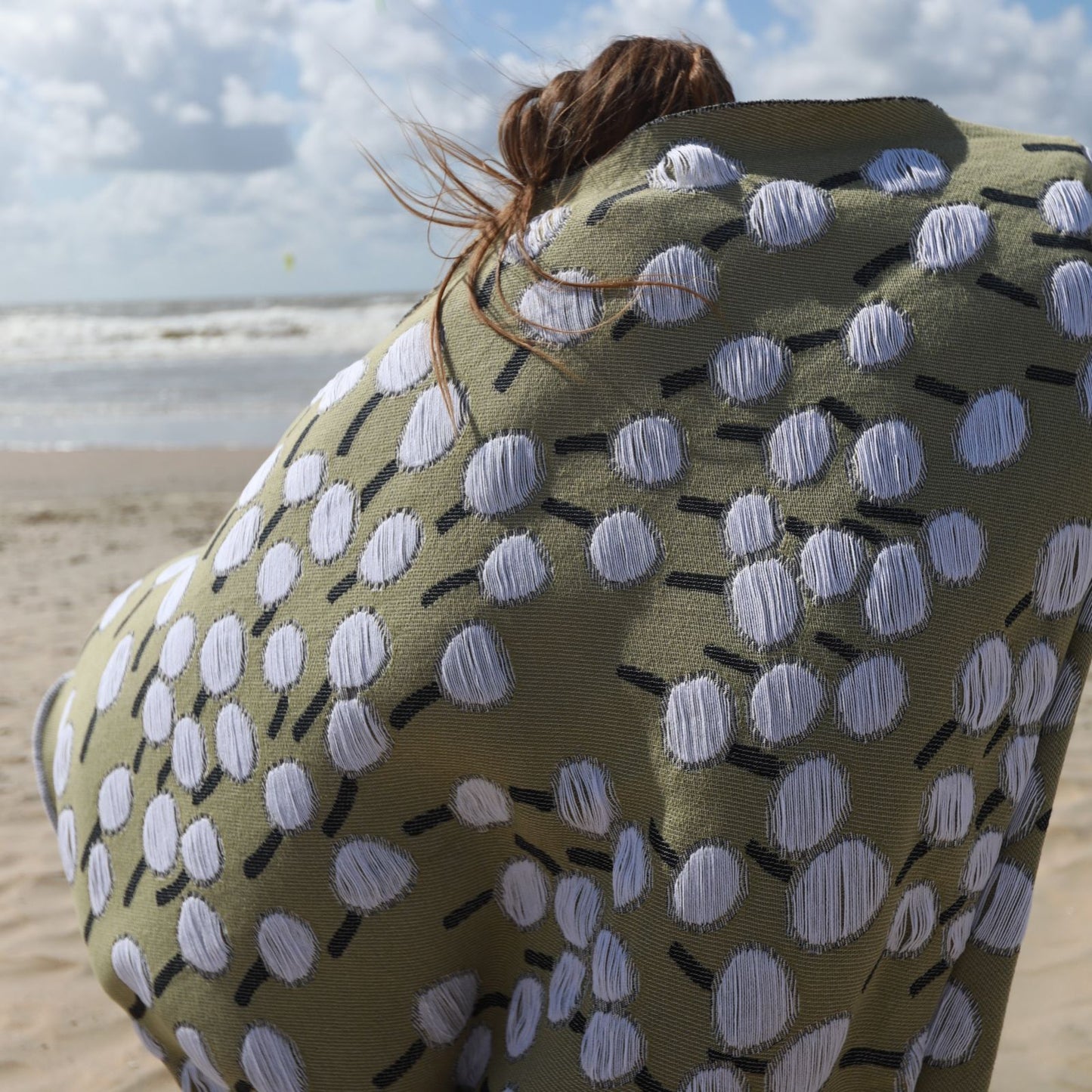 Detail of blanket with 'Make a Wish' design featuring a dandelion pattern designed by Liucija Kostiva